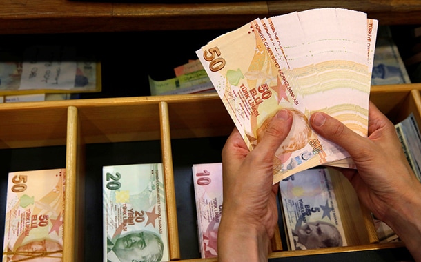 A money changer counts Turkish lira banknotes at a currency exchange office in Istanbul, Turkey August 13, 2018. REUTERS/Murad Sezer - RC139D2160B0